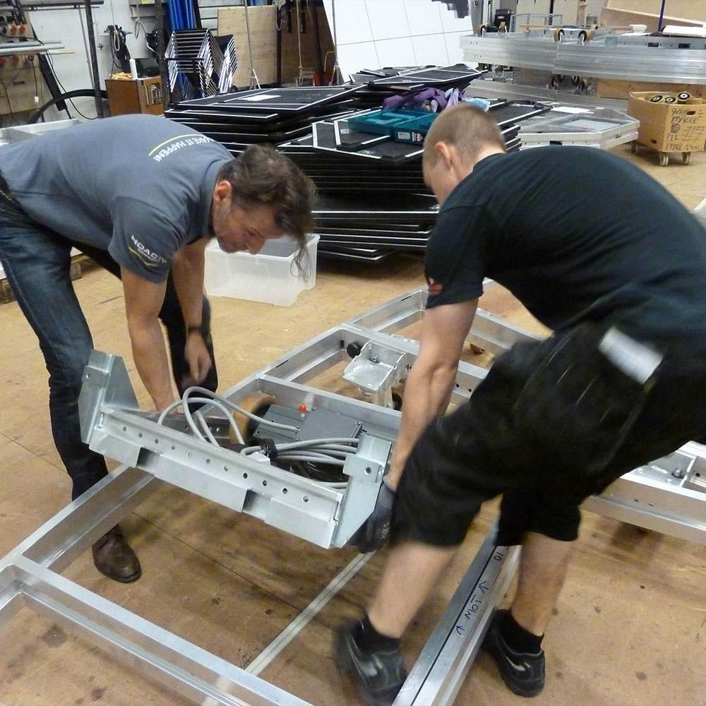 Two men during the construction of a revolving platform stage
