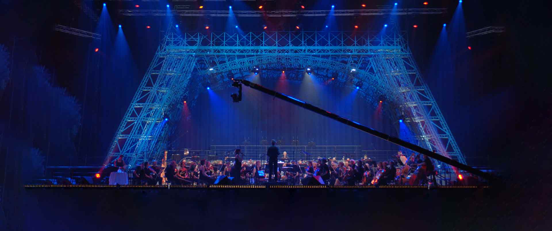Stage with orchestra with an Eiffel Tower in the background of the stage set