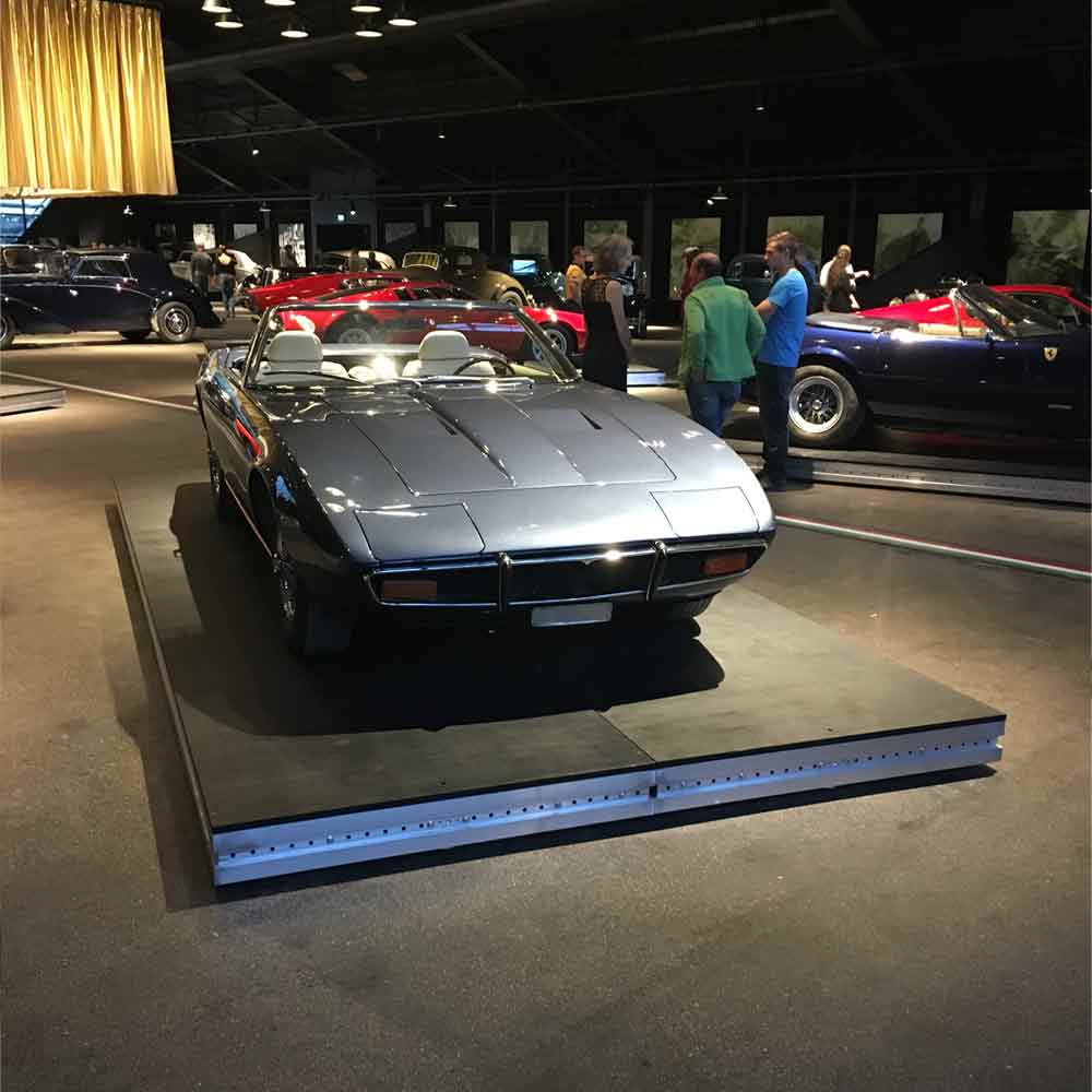 A classic car on a mobile stage wagon