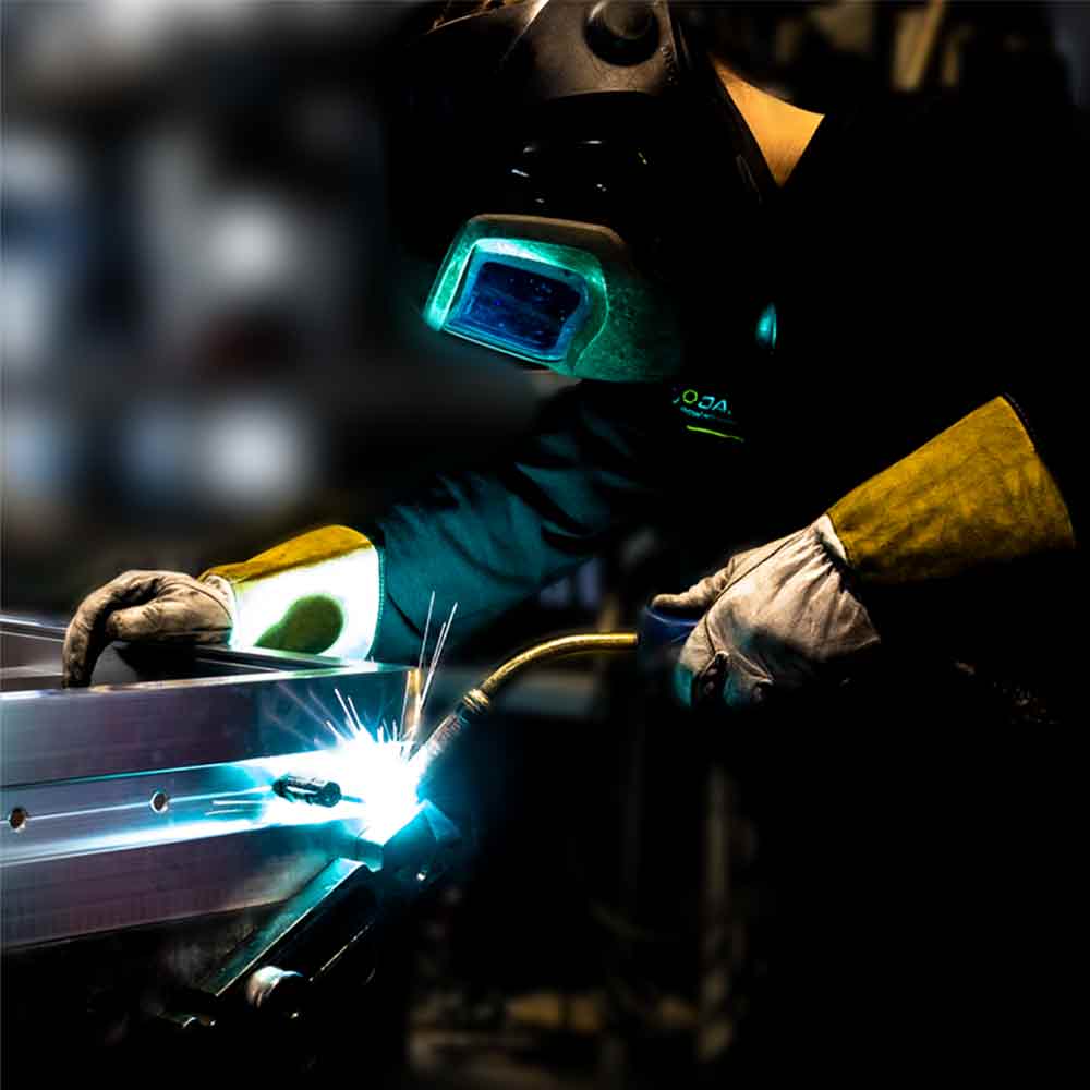 HOAC employee welds aluminum for a custom-made mobile product