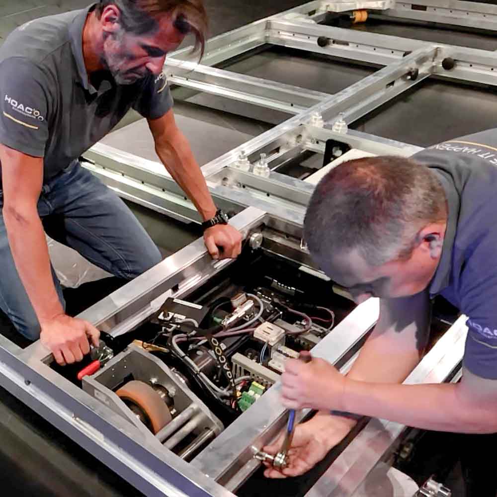 Two men setting up a mobile stage wagon