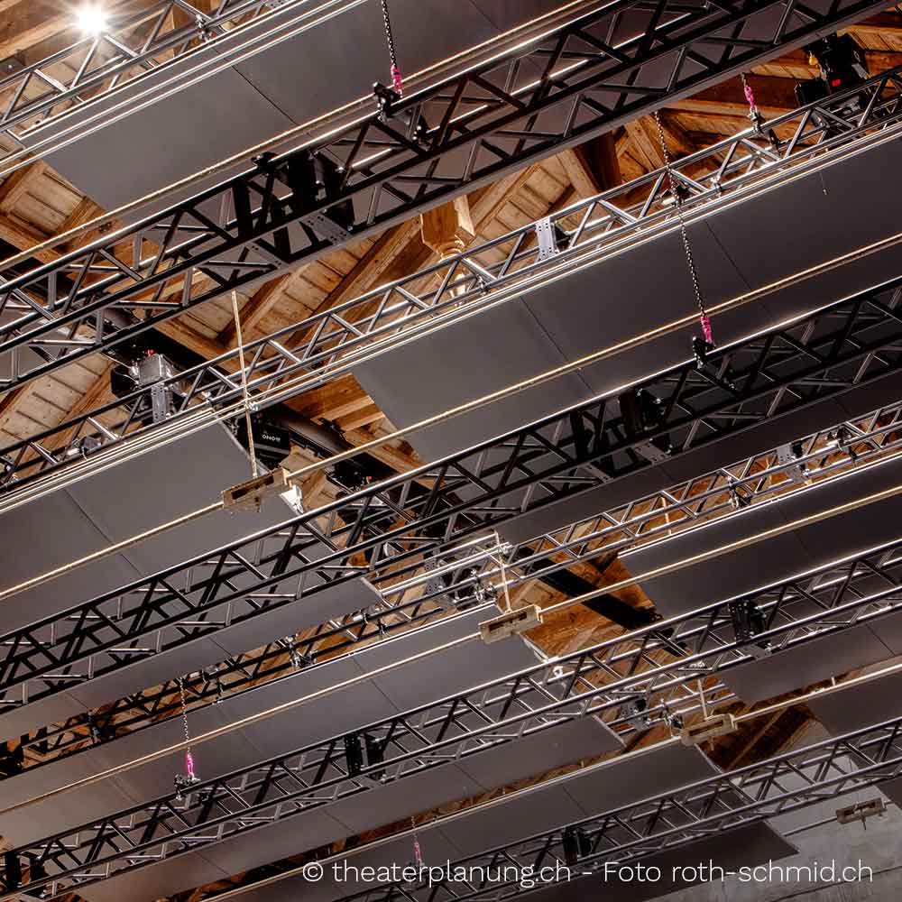 Several trusses barely visible hanging from the ceiling