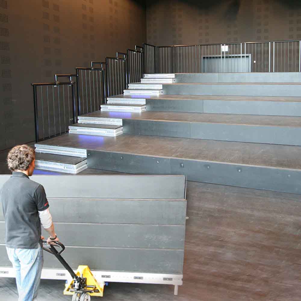 A man sets up a telescopic grandstand